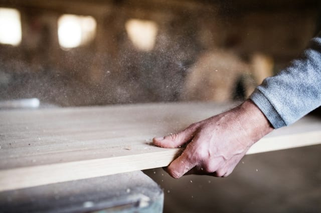 Hand planing oak timber on a workbench